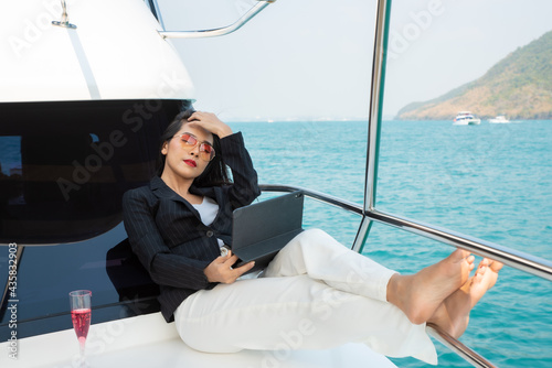 Asian young businesswoman with laptop at the yacht in summer © ic36006