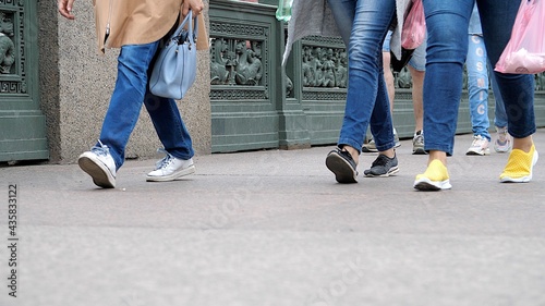 Legs of people walk on the street. Crowd of people walking in pedestrian zone / downtown / old town. Urban scene of typical day in modern city. City Crowd. Lot of Legs walking along the sidewalk