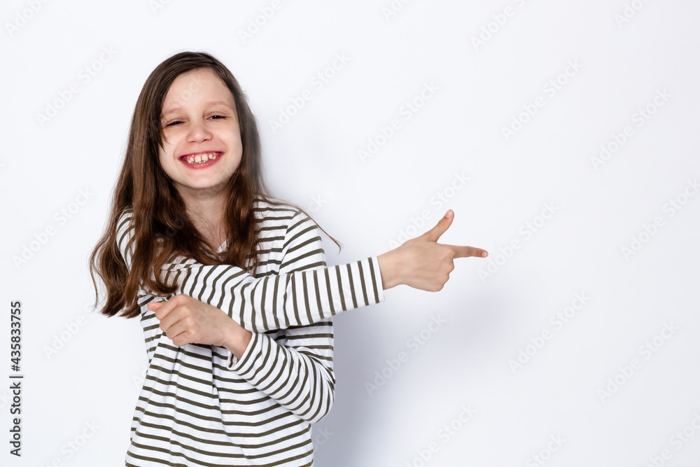 Funny dark-haired girl shows gesture with her hands. On a light background. Space for text Funny dark-haired girl shows gesture with her hands. On a light background. Space for text