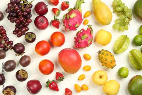 Assortment of fresh exotic fruits on white background, flat lay