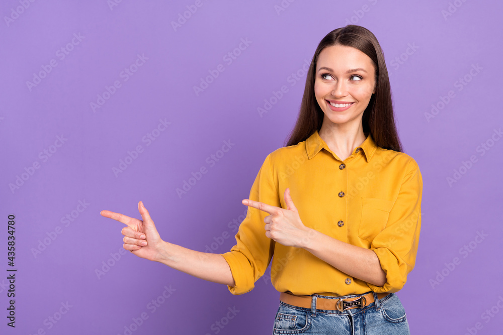 Photo portrait of woman smiling pointing looking copyspace isolated on pastel violet color background Photo portrait of woman smiling pointing looking copyspace isolated on pastel violet color background