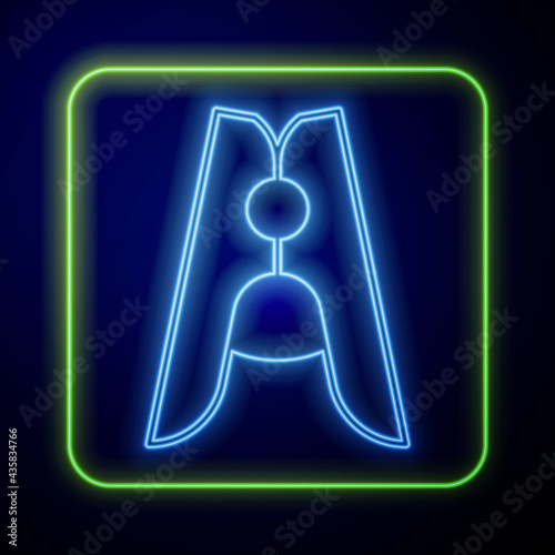 Glowing neon Old wood clothes pin icon isolated on blue background. Clothes peg. Vector