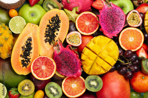 Many different delicious exotic fruits as background  top view