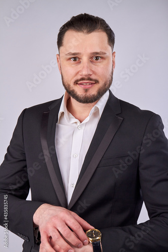 Portrait of young businessman with luxury hand watch.