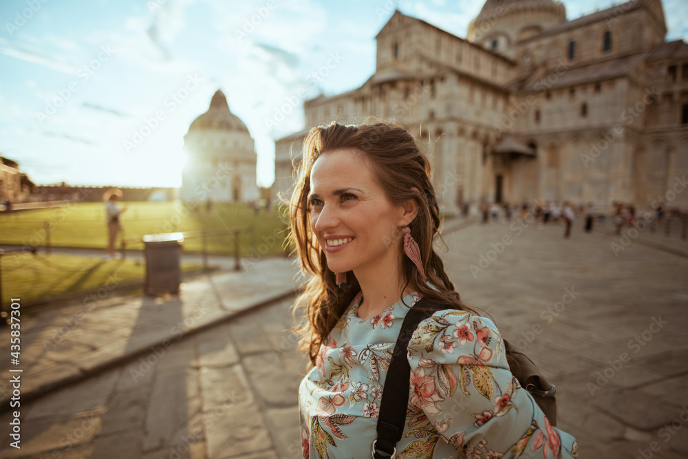 happy stylish woman in floral dress enjoying promenade