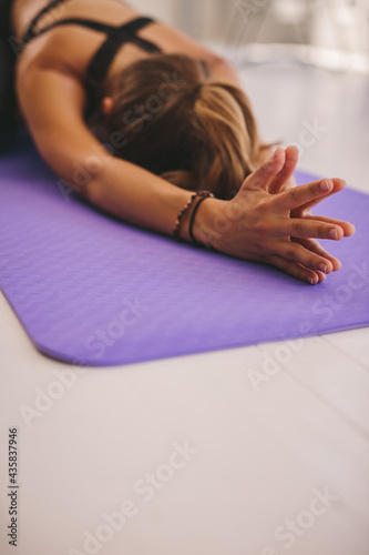 Woman doing child pose yoga at gym
