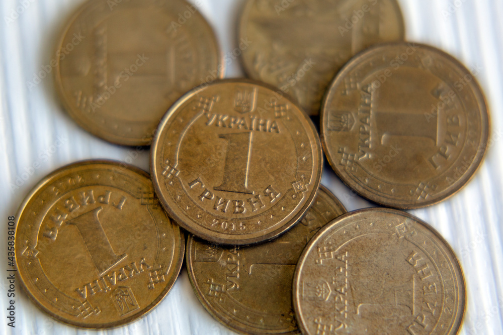 Ukrainian currency hryvnia coins on a white background. Ukrainian money. Inflation, business, economics and finance theme. Ukrainian currency hryvnia coins on a white background. Ukrainian money. Inflation, business, economics and finance theme.