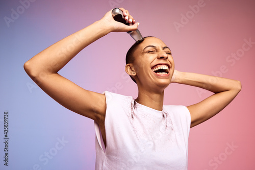 Bold and liberated woman shaving her head photo
