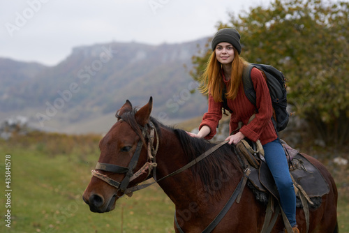woman hiker mountains nature riding horse fun