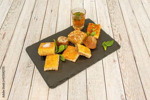 baklava cakes with sesame, coconut, pistachio and coconut zest, all garnished with peppermint leaves photo