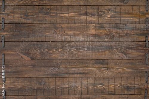 dark varnished wooden plank background with black metal trim