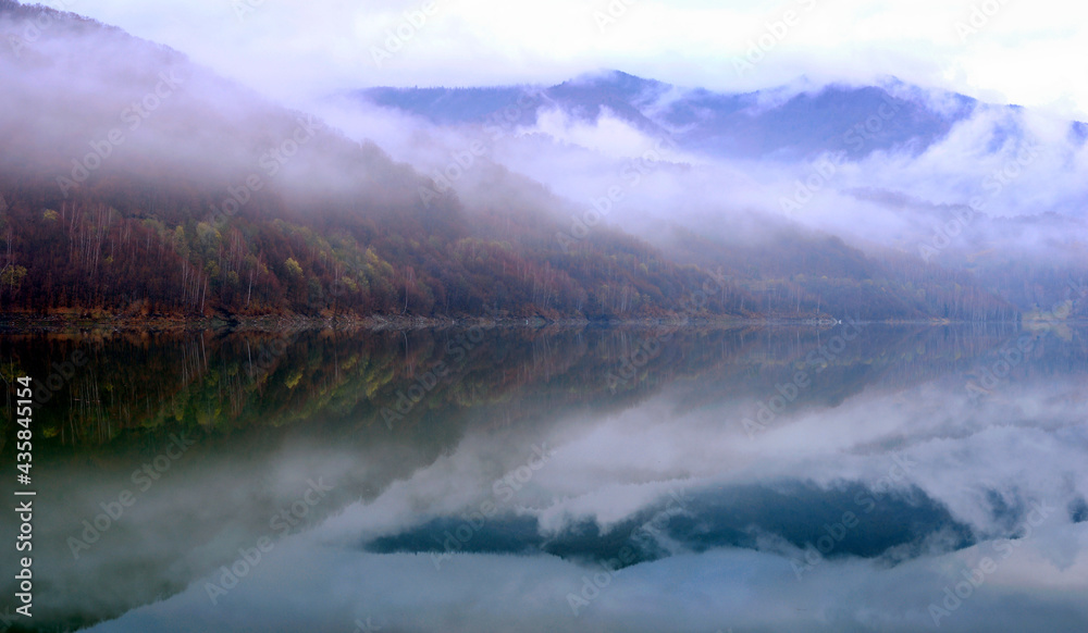 Lake and forest reflection scene in late Winter with fog. Lake and forest reflection scene in late Winter with fog.