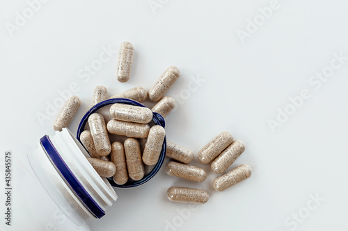 topview of super enzymes capsules in the jar, with negative space. dietary supplement copyspace. mental wellbeing and personal health concept photo