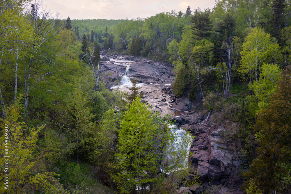High angle view of waterfall and trees along north shore of Lake Superior in Minnesota