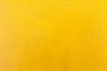 Cement wall painted yellow texture and background seamless