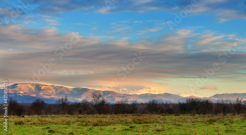 Snow covered mountain peaks in sunset. Location is Tarcu Mountains in Romania