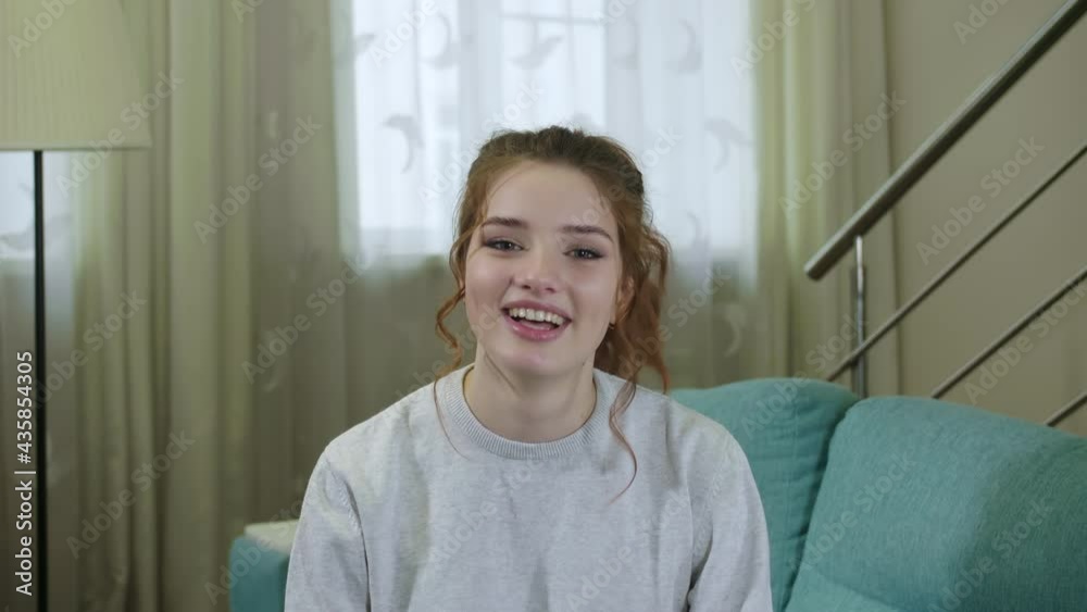 Smiling Young Woman Blogger Vlogger Influencer Sit At Home Speaking Looking At Camera Talking Make Video Conference Call Record Lifestyle Blog Vlog Doing Videochat At Home Concept, Webcam View Smiling Young Woman Blogger Vlogger Influencer Sit At Home Speaking Looking At Camera Talking Make Video Conference Call Record Lifestyle Blog Vlog Doing Videochat At Home Concept, Webcam View