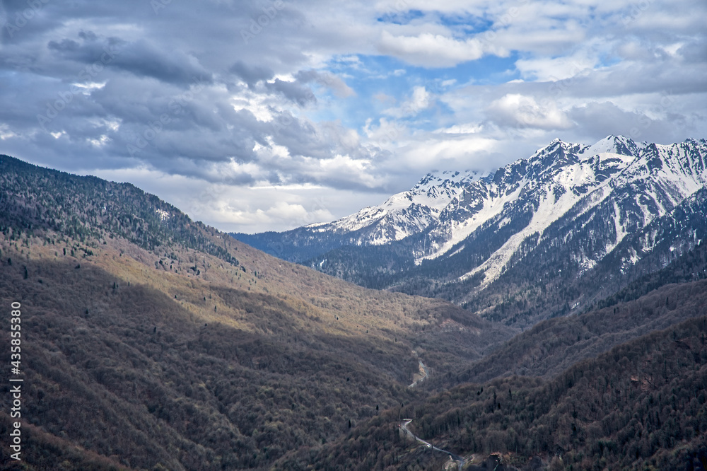 Mountain snow-capped peaks in the clouds. Tourist routes. Extreme tourism, extreme sports. Climbing the peaks. Mountain snow-capped peaks in the clouds. Tourist routes. Extreme tourism, extreme sports. Climbing the peaks.
