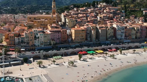 Aerial footage pan going up showing the Vieux Port, Sablette beach, Saint Michel Basilica - Menton, France | Pearl of French Riviera, Côte d'Azur by Drone photo