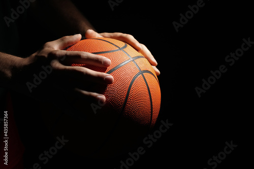 Basketball player with ball on black background, closeup. Space for text © New Africa