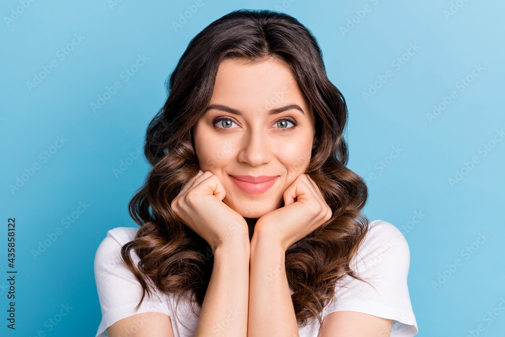 Photo of dreamy charming young woman wear white t-shirt arms cheekbones chin smiling isolated blue color background Photo of dreamy charming young woman wear white t-shirt arms cheekbones chin smiling isolated blue color background