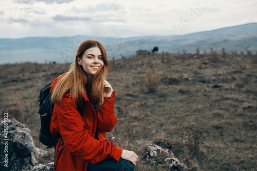 beautiful traveler with a backpack are resting in the mountains on nature landscape autumn