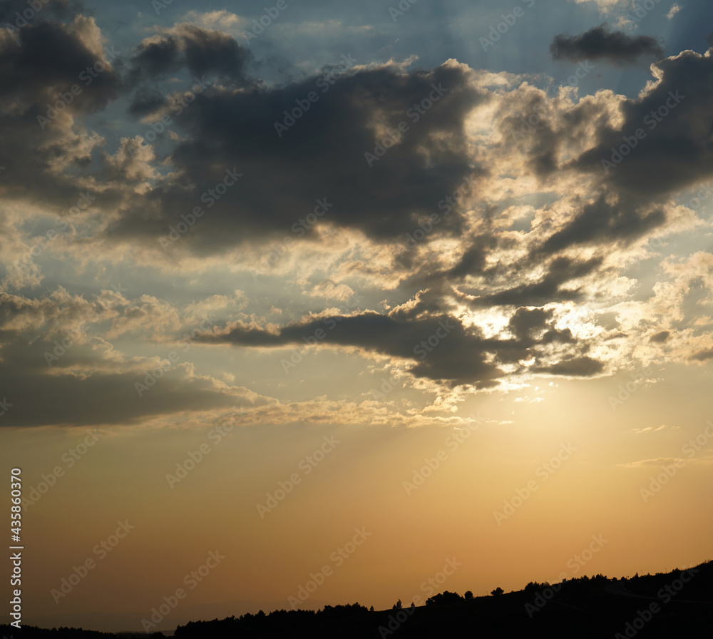 sun lights filtering through the clouds