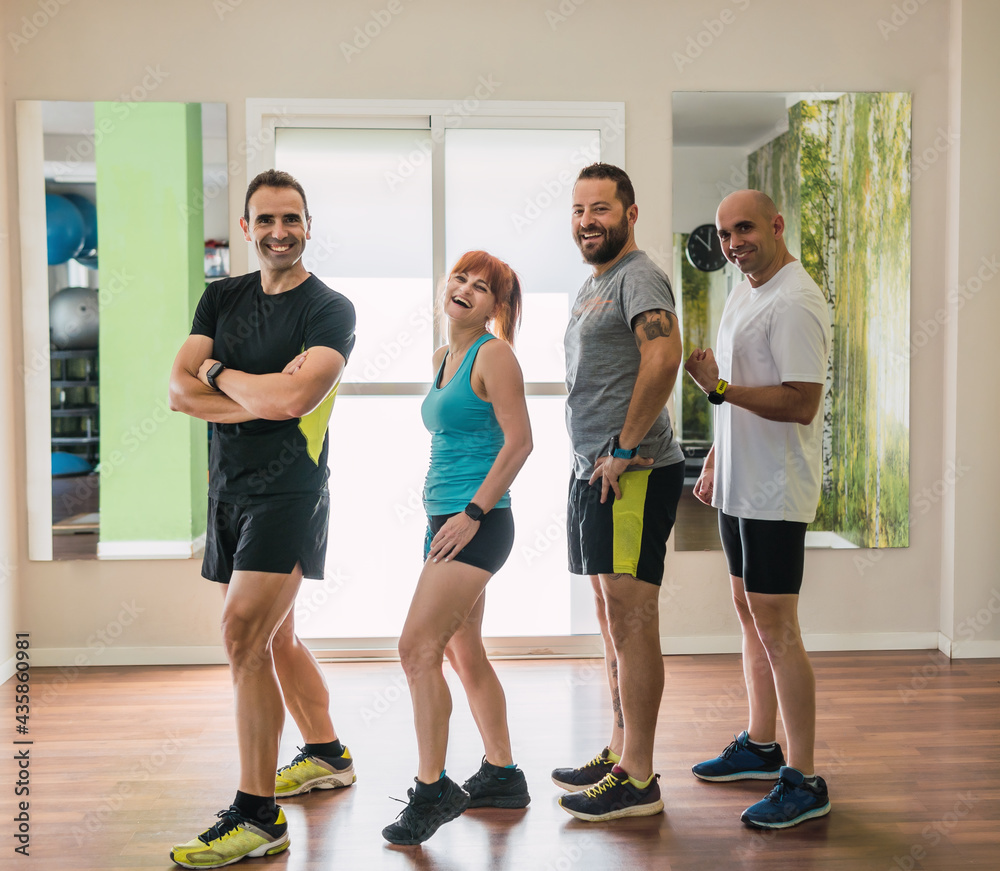 Fototapeta premium Group of people posing in a gym