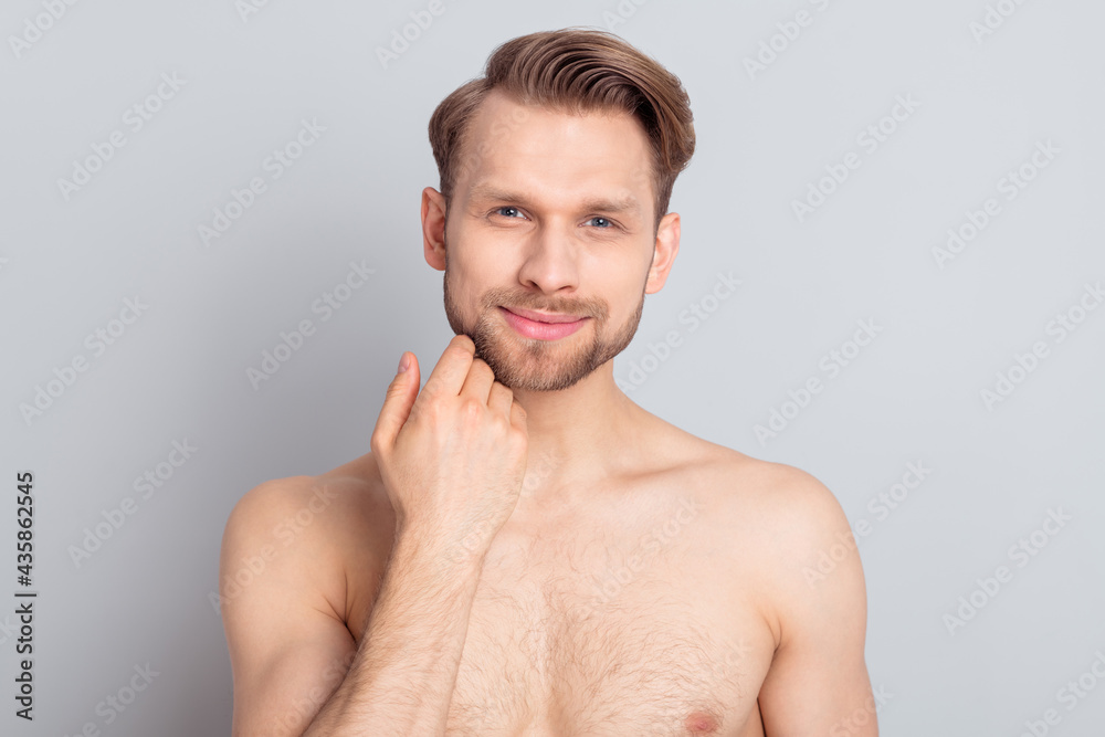 Photo of optimistic blond hairdo guy touch beard without clothes isolated on grey color background Photo of optimistic blond hairdo guy touch beard without clothes isolated on grey color background