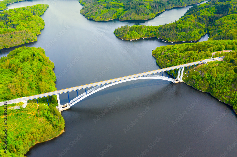 The Zdakovsky Bridge over Orlik reservoir is largest single-arch bridge in the world. Aerial view to famous monument in Czech republic, Central Europe.