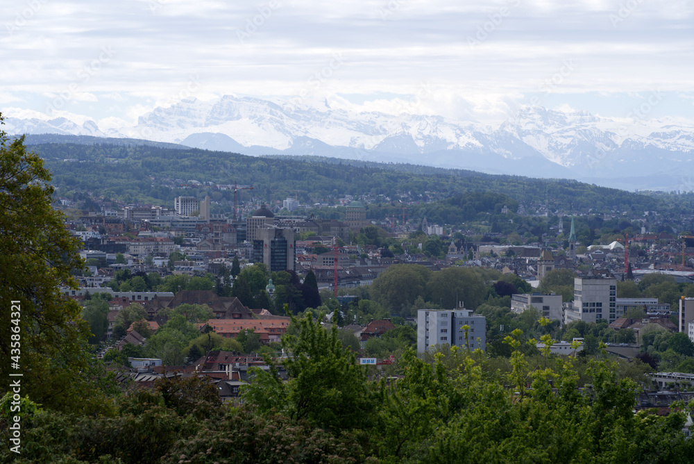 Zurich skyline at springtime with mountains in the background. Photo taken May 26th, 2021, Zurich, Switzerland.