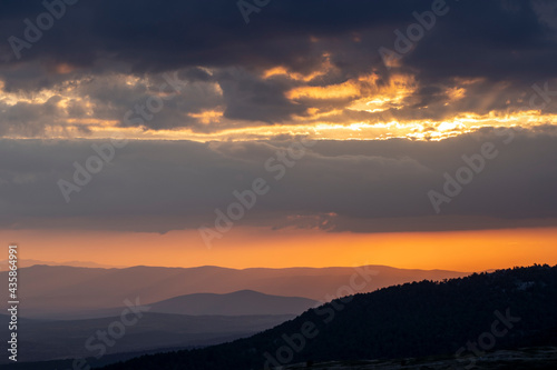 clouds and mountains in the sky at sunset © scetin