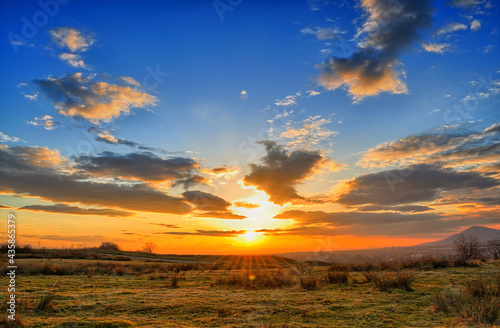 Colorful spring sunset with Sun rays coloring the clouds