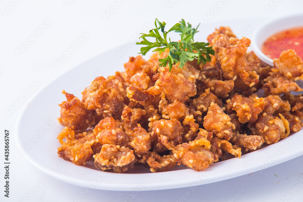 Thai crispy fried chicken on white plate. Thai crispy fried chicken on white plate.