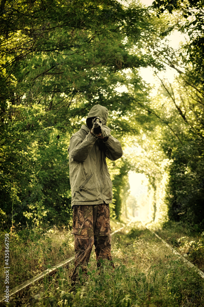 Camouflage hunter aiming with his rifle Camouflage hunter aiming with his rifle