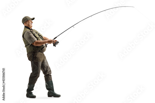 Murais de parede Full length profile shot of a mature fisherman in a uniform fishing