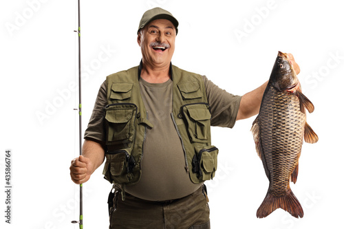 Happy fisherman holding a big carp fish and smiling photo