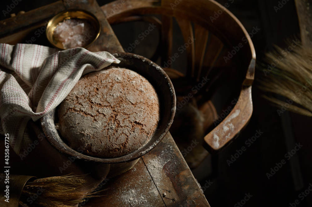 Bowl with rye bread and napkin on table