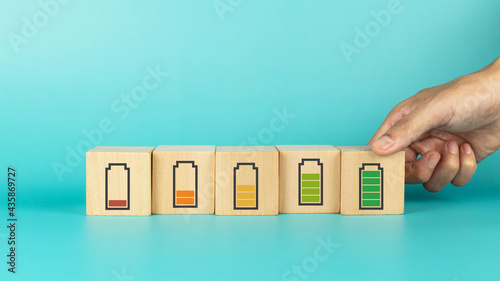 Fotografija Hand hold wooden cube with full level energy battery green