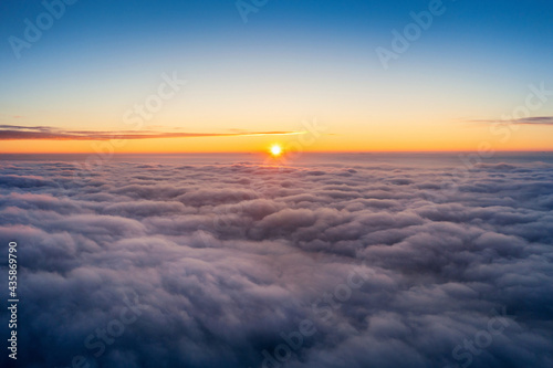 View of over clouds panorama at sunrise.