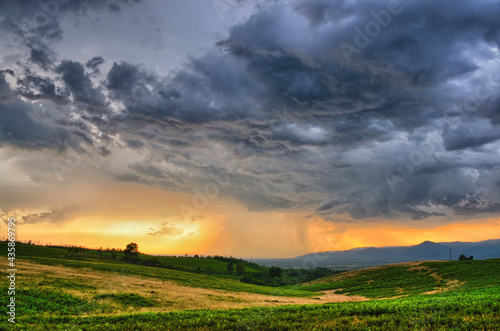 Dramatic storm scene with rain at the horizon