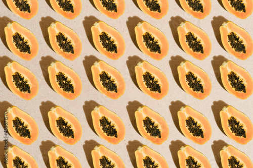 Creative pattern with tropical summer papaya fruit with black seeds on sandy beach background. Minimalist nature and holiday concept. top view