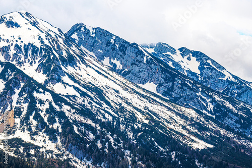 Mountain with snow and white clouds in Italy