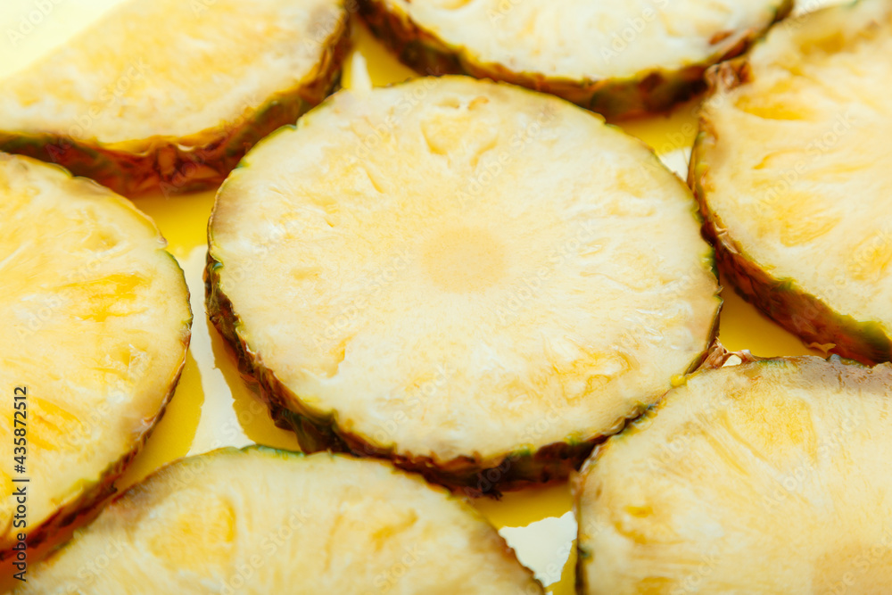 Sliced pineapple circles Background. Food fruit tropical yellow summer background surface texture. Pineapple pattern. Sliced pineapple circles Background. Food fruit tropical yellow summer background surface texture. Pineapple pattern.