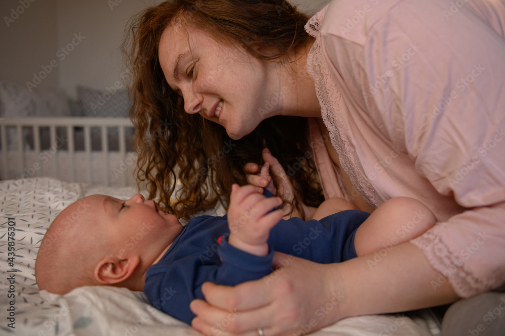 Mother playing and bonding with her baby Mother playing and bonding with her baby