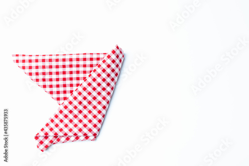 Top view napkin checkers red and white place on a white background. Fabric red and white Isolated with copy space. © Chaiwat