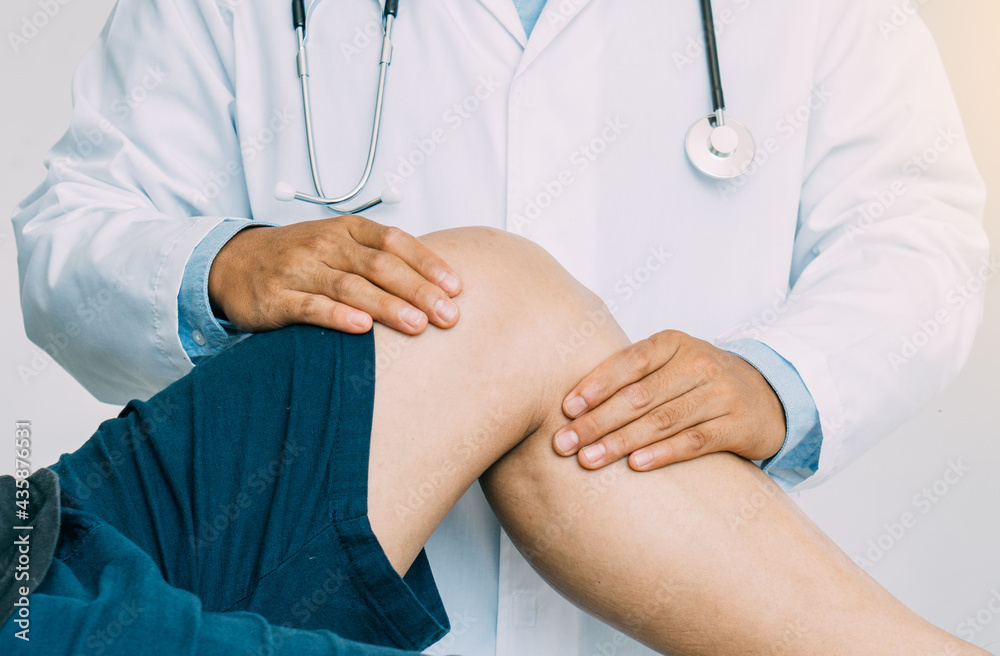 Physiotherapist treating with patient about elbow pain problems.Physical therapy concept Physiotherapist treating with patient about elbow pain problems.Physical therapy concept