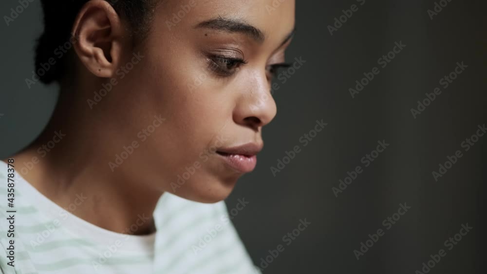 A close-up view of a thinking american woman is working sitting in the office