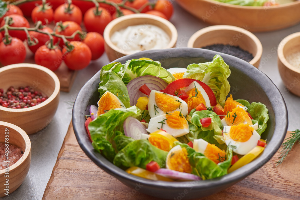 Diet menu. Healthy salad of fresh vegetables - tomatoes, egg, Onion. high angle view of a nutritious vegetable salad with boiled egg slices, served. Healthy meal concept. Diet menu. Healthy salad of fresh vegetables - tomatoes, egg, Onion. high angle view of a nutritious vegetable salad with boiled egg slices, served. Healthy meal concept.