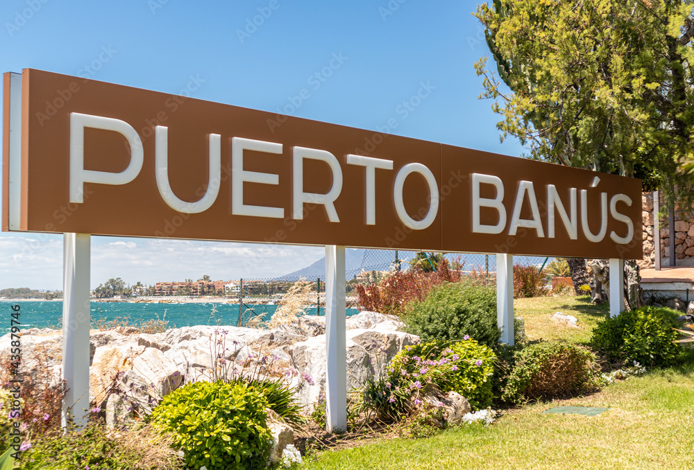 Puerto Banus sign in famouse travel destination and luxury harbour of  Marbella - Costa del Sol. Shopping area, restaurants, night lifestyle.  Stock Photo